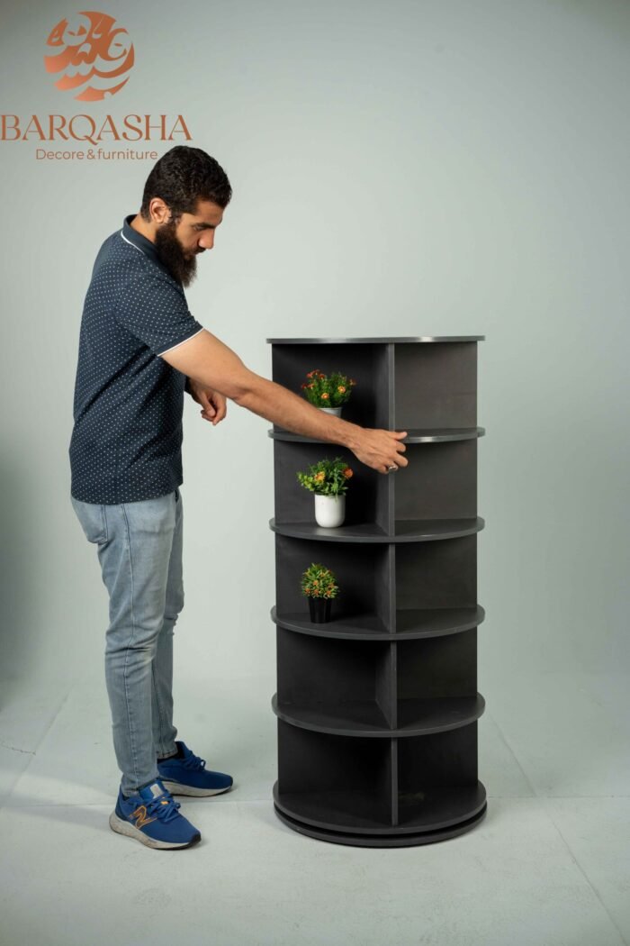 a man rotating dark grey rotatable shoe storage contains decorative plants with a white background and logo barqasha